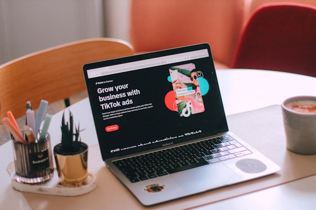 A laptop displays the TikTok ads page on the TikTok website.