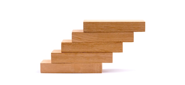 Rectangular wooden tiles are stacked to look like a ladder. 
