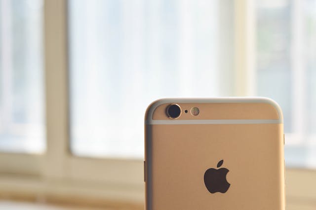 A close-up shot of an iPhone and its camera lens.