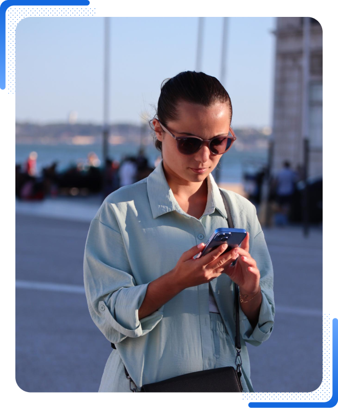 High Social stock image of a woman looking down at her phone to check TikTok account information.