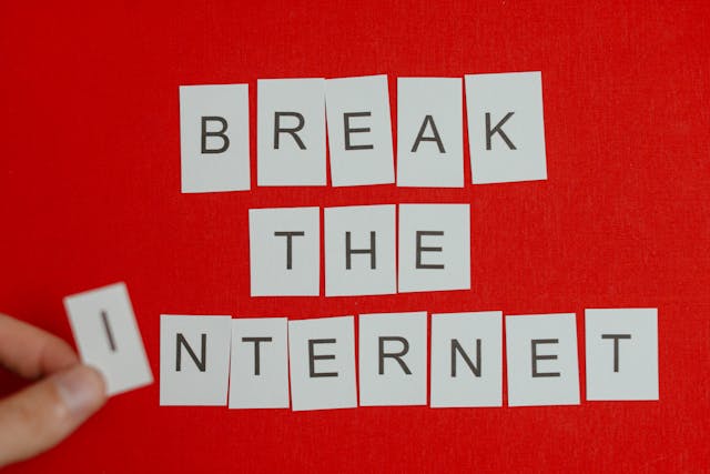 Cut-out letters that spell “Break the internet” against a red background.